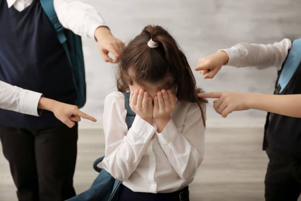 Sad parent comforting a stressed child affected by school bullying in India