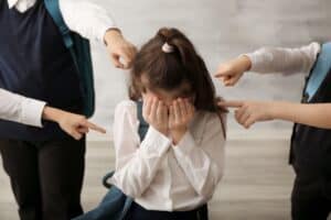 Sad parent comforting a stressed child affected by school bullying in India
