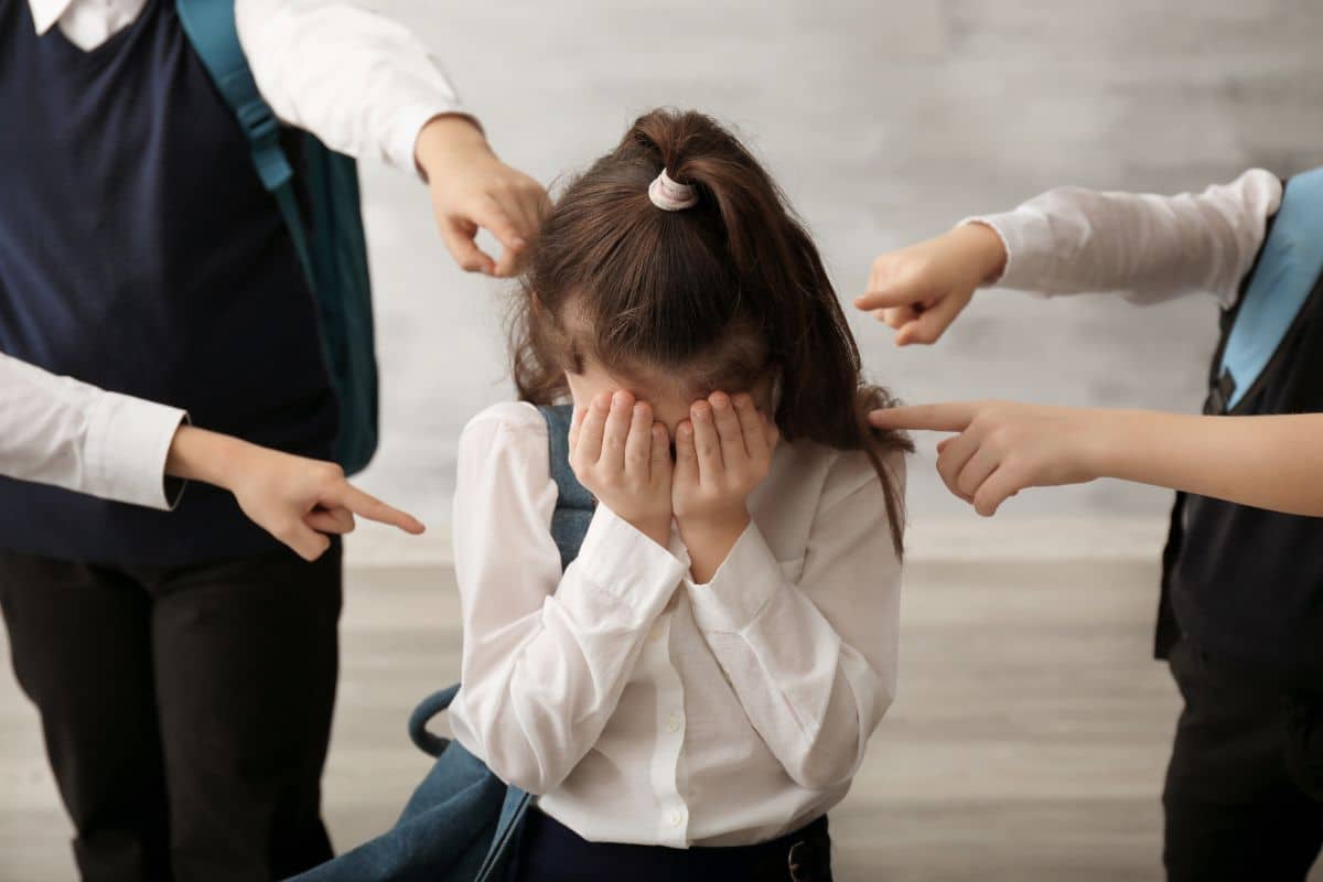 Sad parent comforting a stressed child affected by school bullying in India