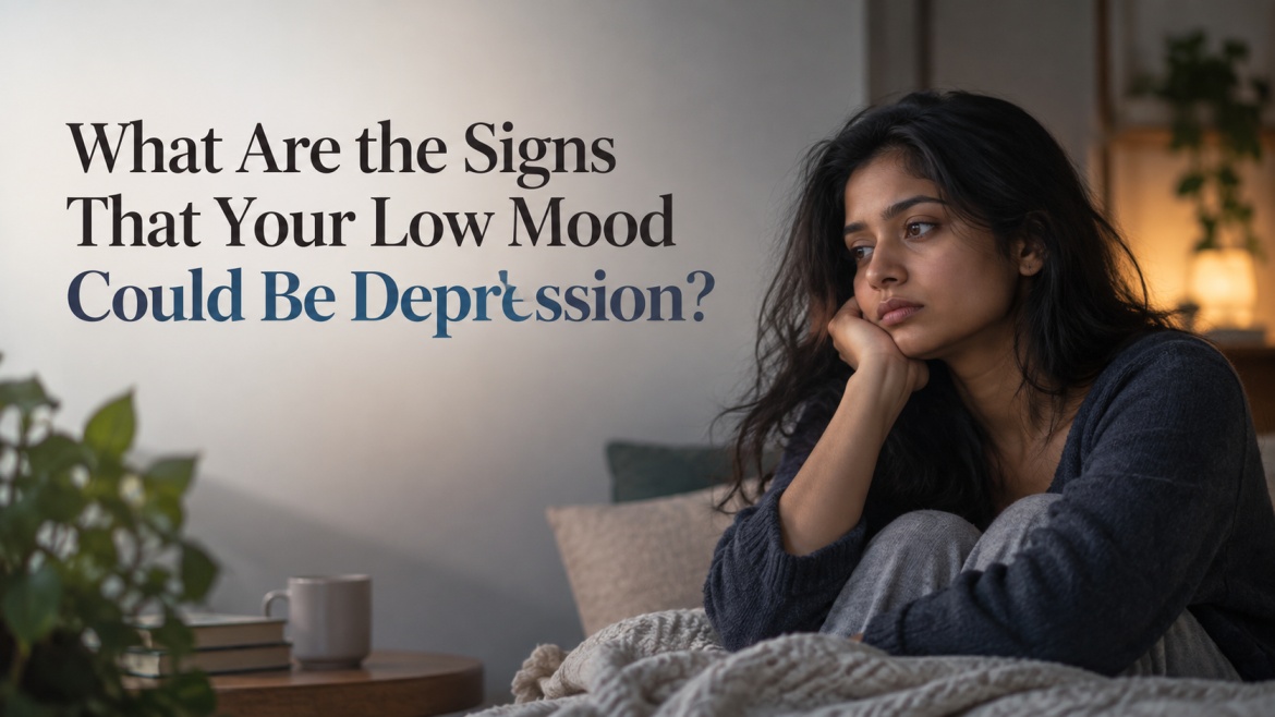 Signs of Low Mood and Depression Young Indian woman sitting alone at home looking emotionally exhausted, illustrating signs of depression and persistent low mood.